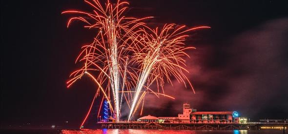 Image of a red firework going off over Bournemouth Pier 