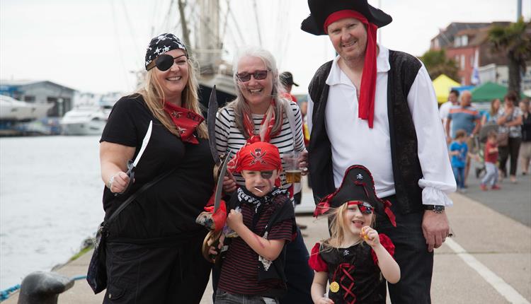 Family dressed up as pirates.