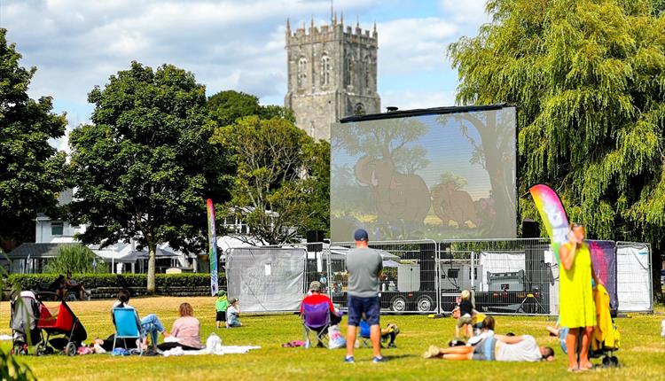 Big screen in Christchurch with the Priory in the background.