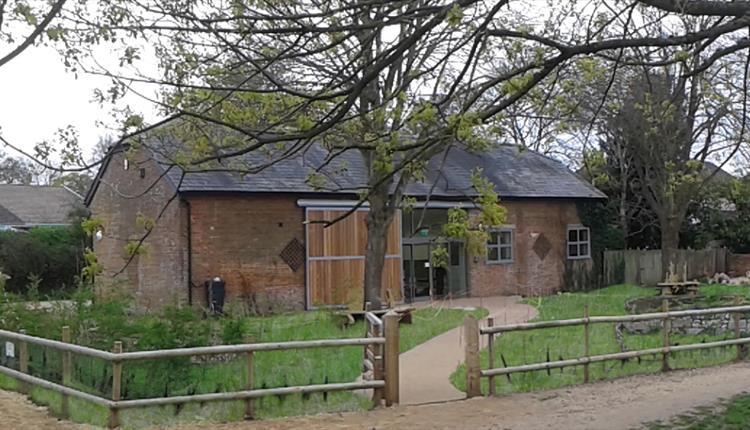 photo of Kingfisher Barn Visitor Centre with trees and garden