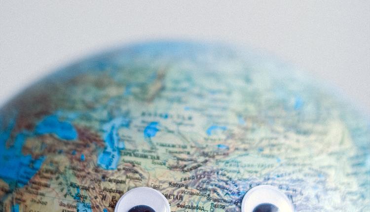 A colourful globe with googly eyes