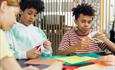 three children doing arts and crafts at a table