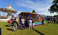 people enjoying the funfair on a sunny day